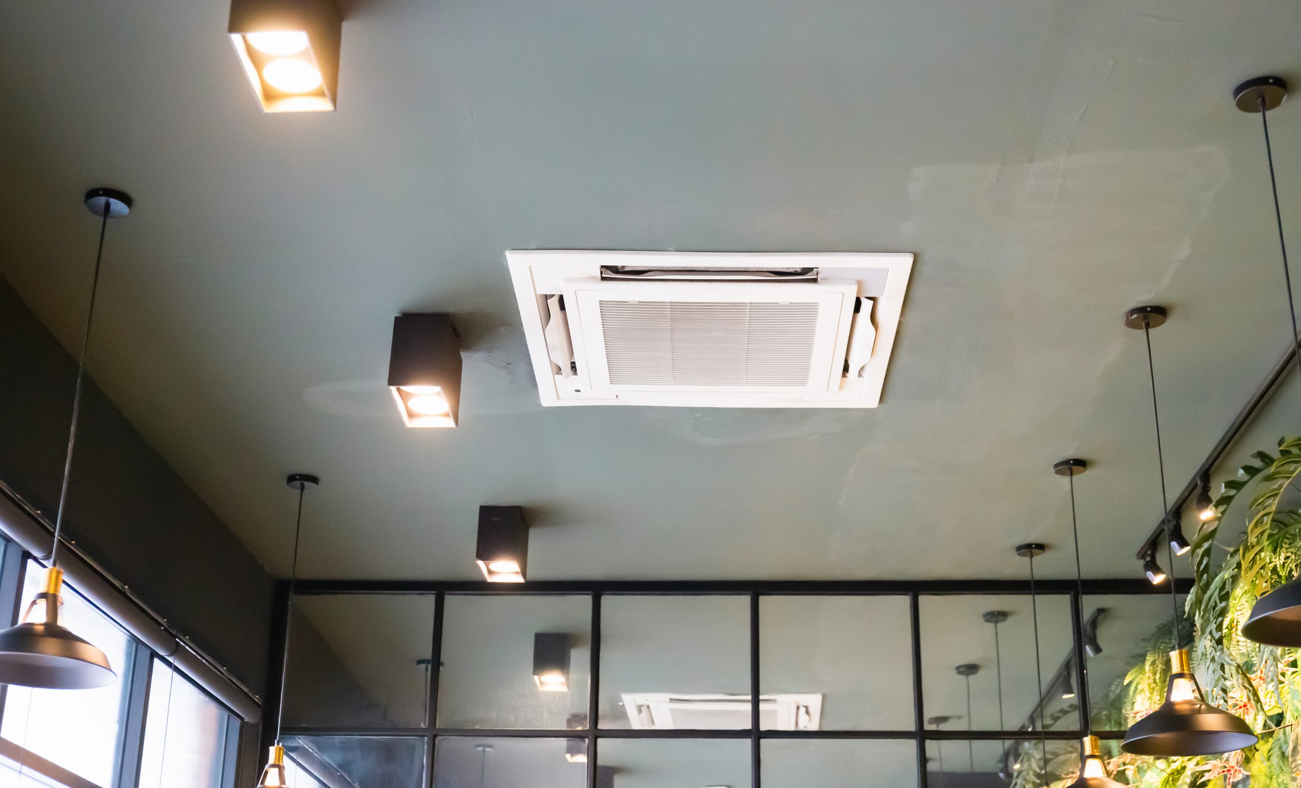 Modern ceiling mounted cassette type air conditioning system in coffee shop